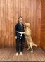 Woman in Brazillian Jiu Jitsu Gi with a dog